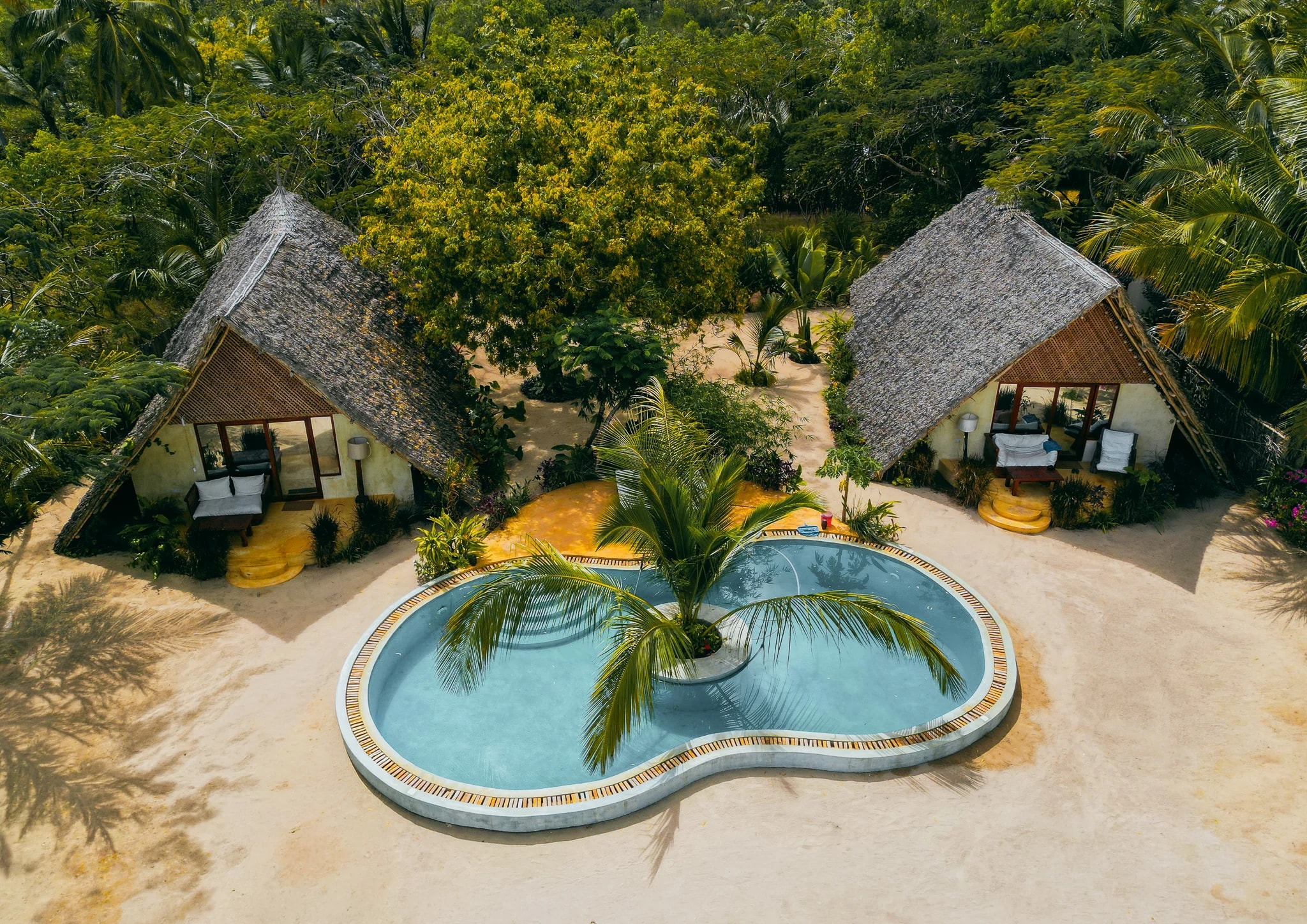 Aerial view of tropical villas surrounding a swimming pool